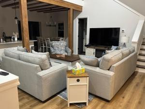 a living room with two couches and a television at Hidden gem at the lake 4 bedrooms in Moneta