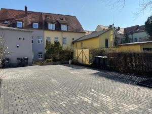 a brick parking lot in front of some buildings at Dein Hideaway - Grimma entdecken und genießen in Grimma