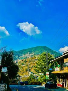 una vista de una montaña con coches aparcados en una calle en askari lodges, en Murree