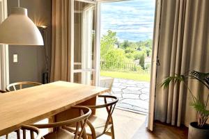 a dining room with a table and chairs and a large window at 250sqm Luxury Villa in Danderyd - near Stockholm in Stocksund
