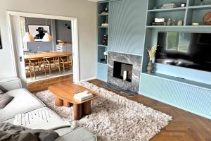 a living room with a couch and a fireplace at 250sqm Luxury Villa in Danderyd - near Stockholm in Stocksund +29 photos