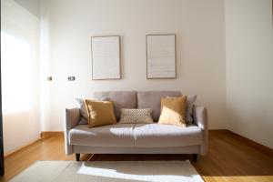 - un canapé dans le salon avec deux photos sur le mur dans l'établissement Tanbolin, à Gautegiz Arteaga