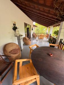 a living room with a wooden table and chairs at Emma's Sea View in Hiriketiya +187 photos