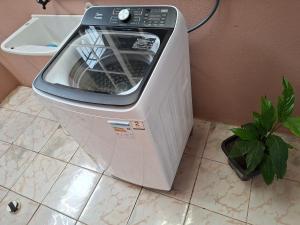 a washing machine sitting on the floor in a bathroom at Casa Ribeiro in Canguçu