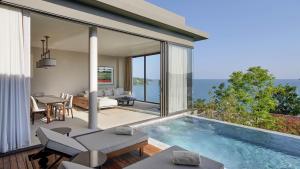 a house with a swimming pool and a living room at V Villas Phuket - MGallery Collection in Panwa Beach
