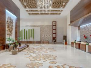 a lobby with a large rug on the floor at Swissôtel Al Ghurair Dubai - Deira & Creek in Dubai +164 photos