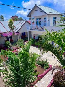 a house with palm trees in front of it at Karibu House Paje in Paje