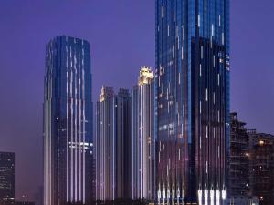 a group of tall buildings in a city at night at Fairmont Chengdu in Chengdu