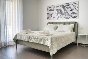 a bedroom with a bed with two towels on it at hiPaestum in Paestum