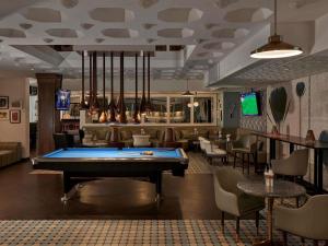 a pool table in a room with a bar at Fairmont Fujairah Beach Resort in Al Aqah