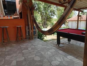 a patio with a pool table and a hammock at Recanto Seu Luis Piscina,Represa e caiaques in Ibiúna