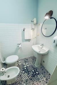 a bathroom with a toilet and a sink at Hotel Aurelia Milano Centrale in Milan +29 photos