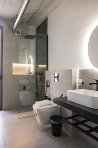 a bathroom with a sink and a toilet and a tub at C Living 3 - Al Malqa in Riyadh +144 photos