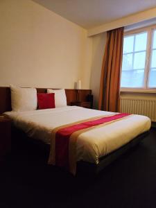 a bedroom with a large bed with a window at Hotel De Notelaer in Bornem +35 photos