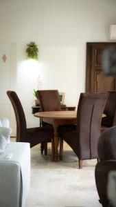 a dining room with a wooden table and chairs at Le Refuge Des Saisons  +9 photos