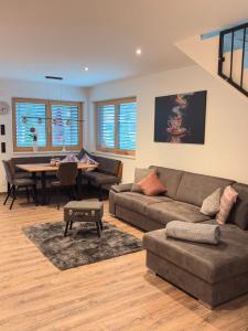 a living room with a couch and a table at APART six-o-nine in Schwendau