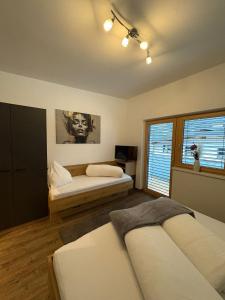a bedroom with two beds and a window at APART six-o-nine in Schwendau