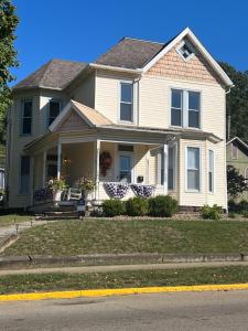 a house with two chairs on the front porch at Guesthouse 214 at Guesthouse Lodging in Millersburg