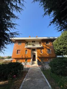 a large brick building with a walkway in front of it at La casa i due cedri in Cuneo