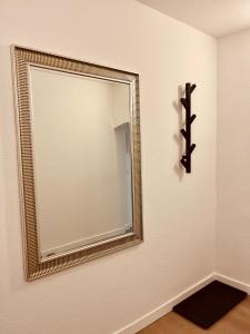 a mirror on a wall in a room at Apartment-am-Burgberg, Harztor in Harztor