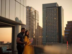 a man and a woman standing on top of a building at Fairmont Austin in Austin