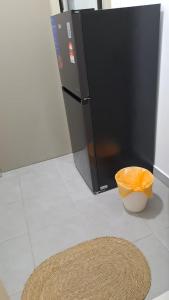 a kitchen with a black refrigerator and a bowl of oranges at Youth City Residence, Nilai 2R2B in Nilai +2 photos