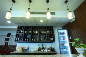 a bar with a shelf with bottles of alcohol at DEWALING by Laughing Lama Hotels in Phuntsholing +19 photos