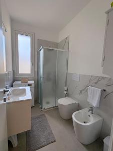 a bathroom with a sink and a toilet and a shower at La Nassa e il Faro in Porticello