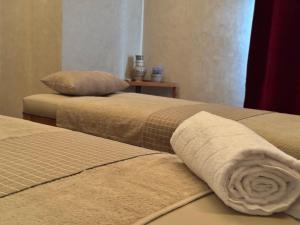 two beds with a rolled up towel on them at Riad Dar Laura in Fès +163 photos