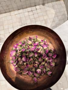 a bowl full of flowers on a table at Riad Dar Laura in Fès