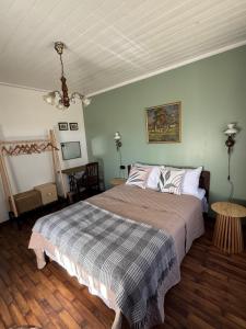 a bedroom with a large bed and a table at Piliakalnio Apartmentai in Kupiškis +28 photos