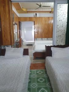 a bedroom with two beds and a room with at Blue Moon Motel in Yên Ha