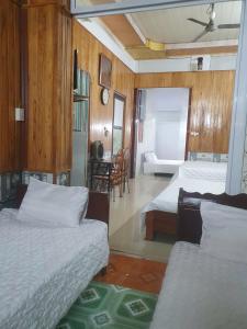 a bedroom with two beds and a living room at Blue Moon Motel in Yên Ha