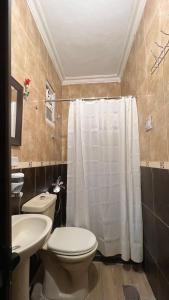a bathroom with a toilet and a sink at Petra center suite in Wadi Musa