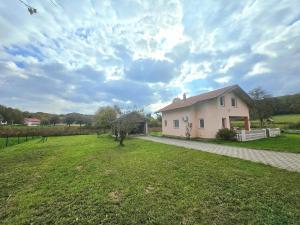 a small white house with a grassy yard at Kuća za odmor Brlog in Brlog +21 photos