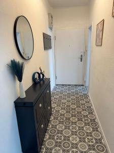 a hallway with a dresser and a mirror and a door at Apartment SNOW in Bruck an der Mur