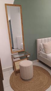 a room with a mirror and a stool and a table at Youth City Residence, Nilai 2R2B in Nilai