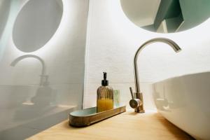 a bathroom with a sink and a bottle on a counter at Stone House in Tîrgu Secuiesc