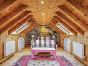 a room with a bench in a attic at Seaton Cottage - Uk31990 in Staithes +36 photos
