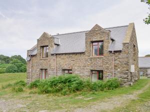 an old stone house in a field at Erw Goed Old Barn in Arthog