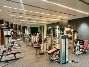 a gym with a bunch of machines in it at Private Sea View Room in 3BR Downtown Apartment Direct Mall & Metro Access in Dubai