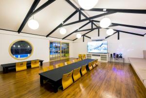 a conference room with a table and yellow chairs at Saga Pool House 5BR, 200m from BEACH in Pattaya North +56 photos
