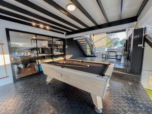 a billiard room with a pool table on a floor at Saga Pool House 5BR, 200m from BEACH in Pattaya North