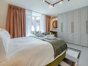 a bedroom with a large white bed with two pillows on it at Restharrow - Uk49244 in Whitstable +9 photos