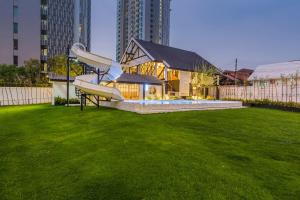 a slide in the middle of a yard with a house at Saga Pool House 5BR, 200m from BEACH in Pattaya North