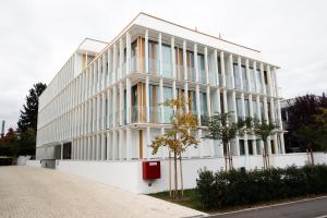 菲尔德施塔特Das Kaya Hotel Stuttgart Airport Messe的街道边的白色建筑,设有窗户