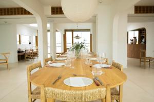 a long wooden table with chairs and plates and wine glasses at Das Kaya Hotel Stuttgart Airport Messe in Filderstadt +87 photos