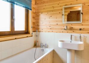 a bathroom with a sink and a bath tub at Laxfield Lodges in Laxfield
