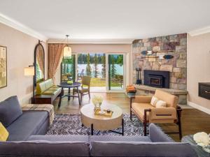 a living room with a couch and a fireplace at Fairmont Jasper Park Lodge in Jasper