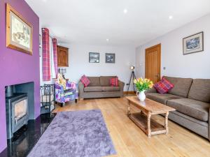 a living room with a couch and a fireplace at Highfields in Runswick